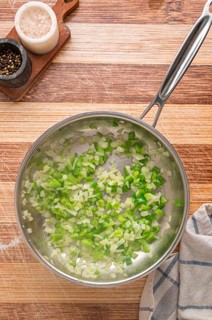 Shredded cheddar, sauteed onions and bell peppers, and Ritz cracker crumbs make this Cracker Barrel Meatloaf extra moist and flavorful. Sauteeing green peppers and onions in a skillet