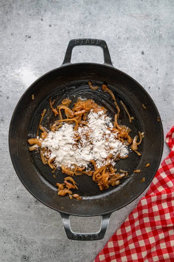 Caramelized onions, a savory onion sauce, and gooey, cheese turn basic meatloaf into an elevated dinner in this French Onion Meatloaf recipe. Flour, butter, and caramelized onions in a skillet