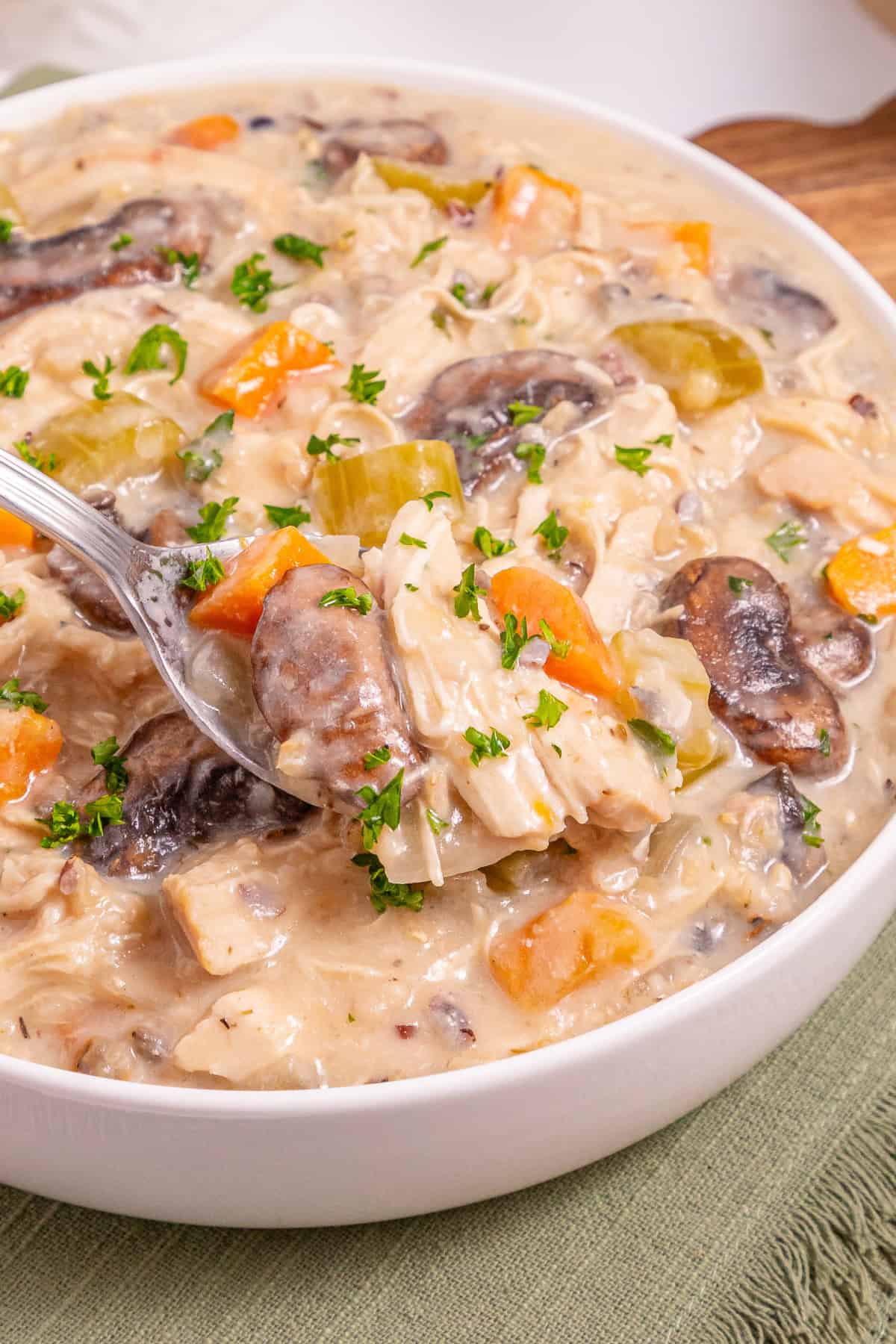 This Crock Pot Chicken Wild Rice Soup is the perfect dump & go crock pot recipe for busy weekdays. Hearty & filling. Crock Pot Chicken Wild Rice Soup in a bowl