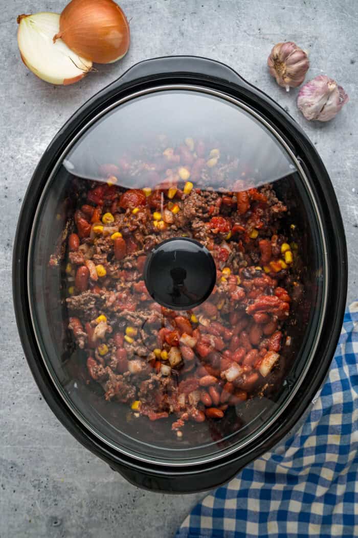 Chili ingredients covered in the slow cooker