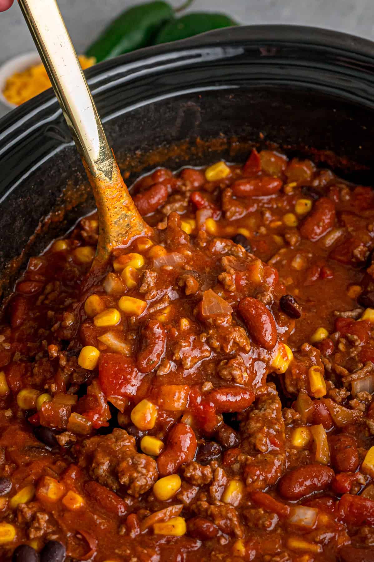 Close up of a ladle scooping crockpot chili