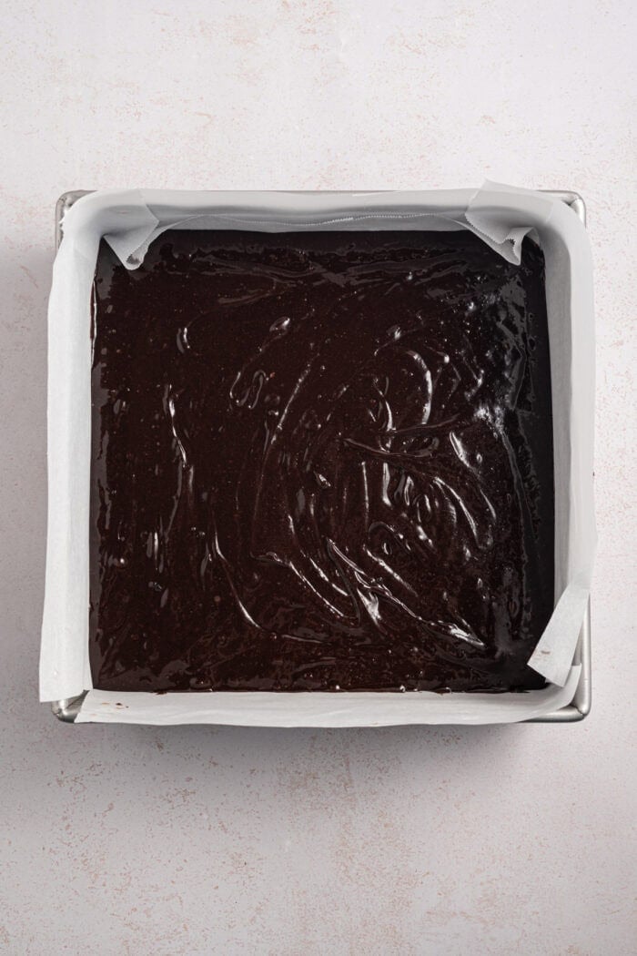 Espresso Brownies feature fudgy, dense chocolate brownies with a hint of espresso, topped with a layer of espresso buttercream frosting. Espresso brownie batter in a square pan