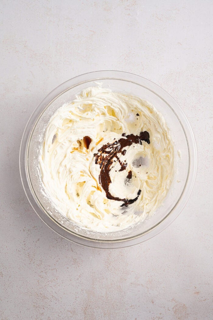 Espresso Brownies feature fudgy, dense chocolate brownies with a hint of espresso, topped with a layer of espresso buttercream frosting. Espresso added to buttercream in a bowl