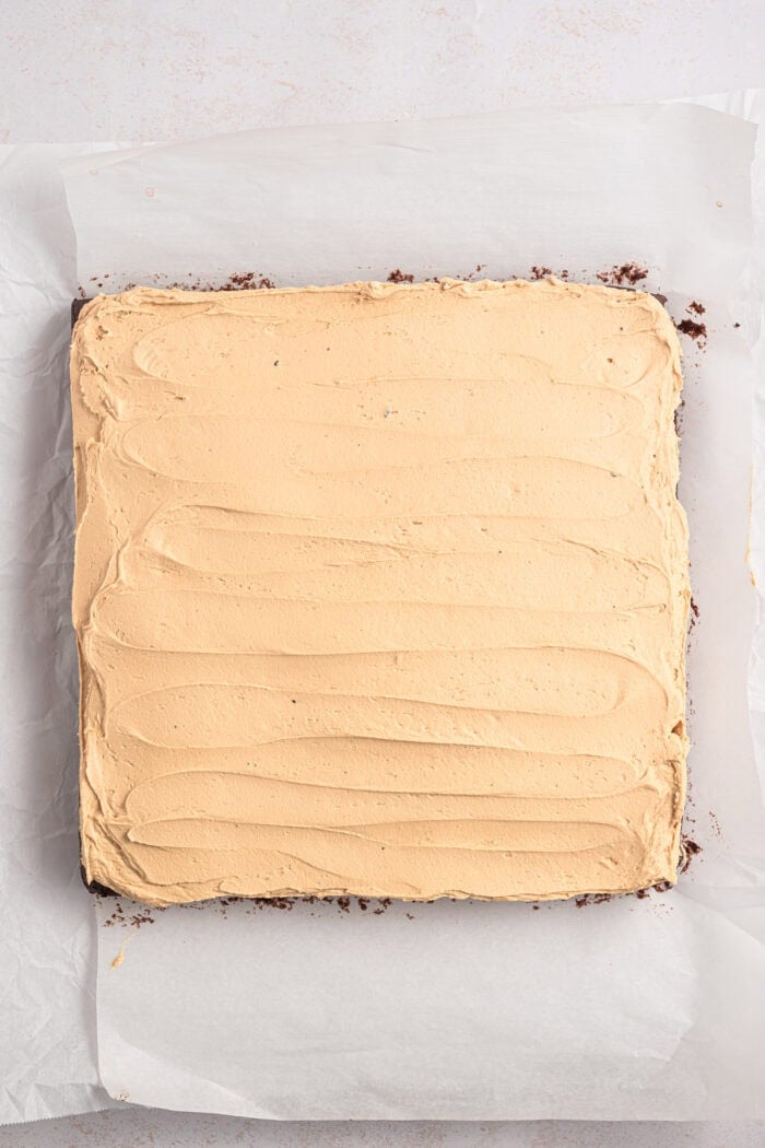 Espresso Brownies feature fudgy, dense chocolate brownies with a hint of espresso, topped with a layer of espresso buttercream frosting. Espresso buttercream spread on brownies