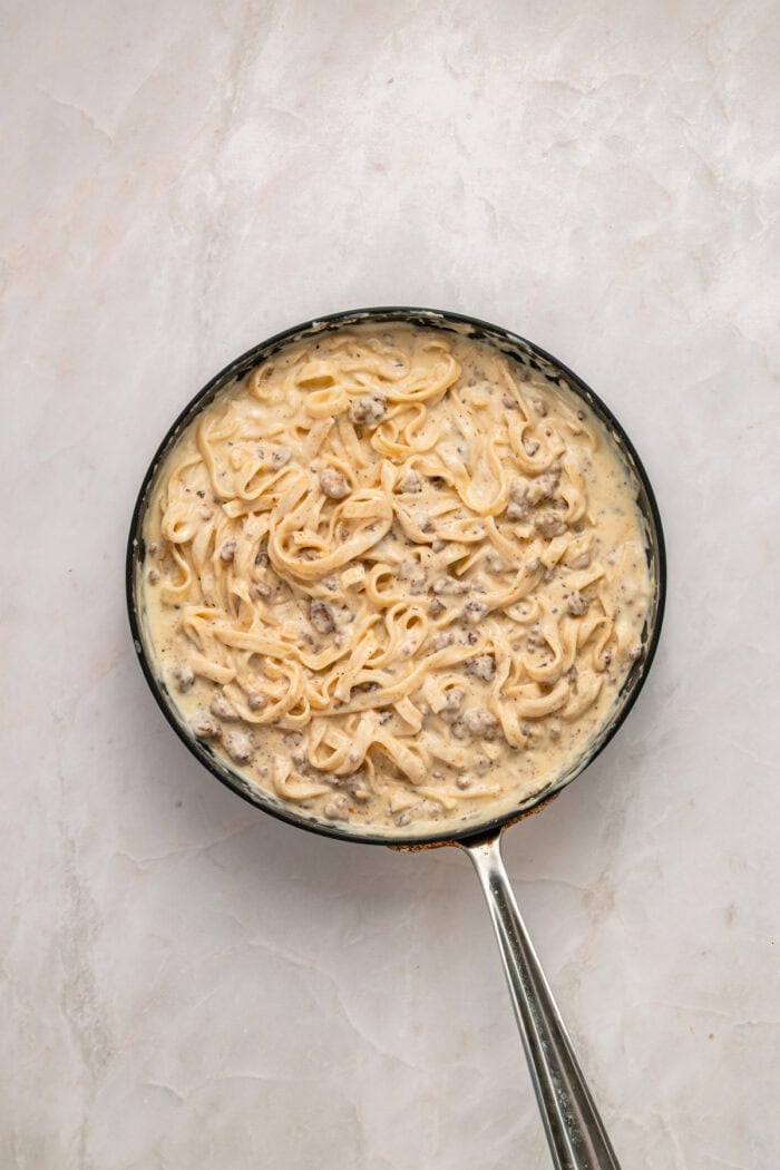 Overhead view of ground beef alfredo in a skillet