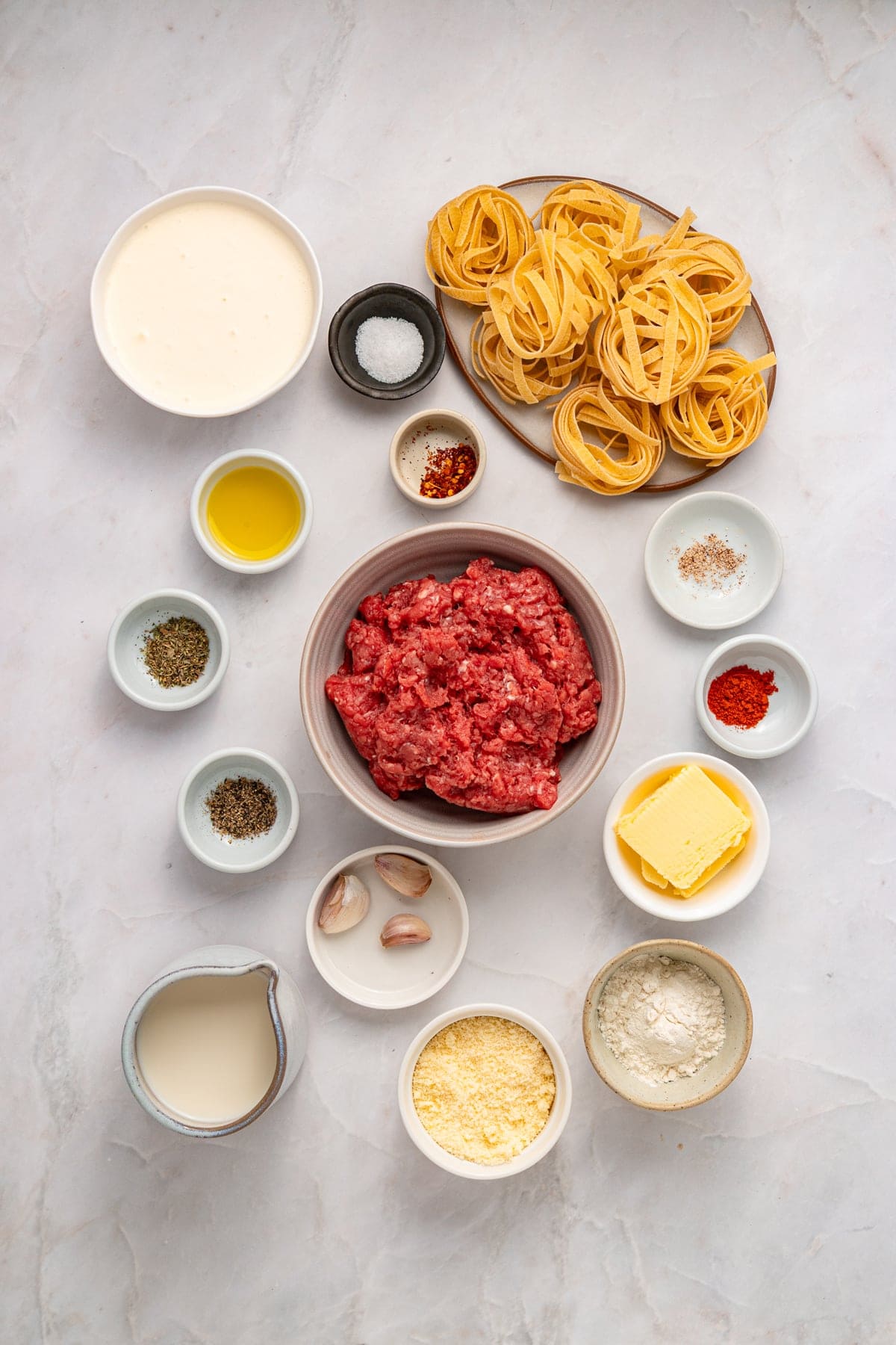 Overhead view of ingredients needed to make ground beef alfredo