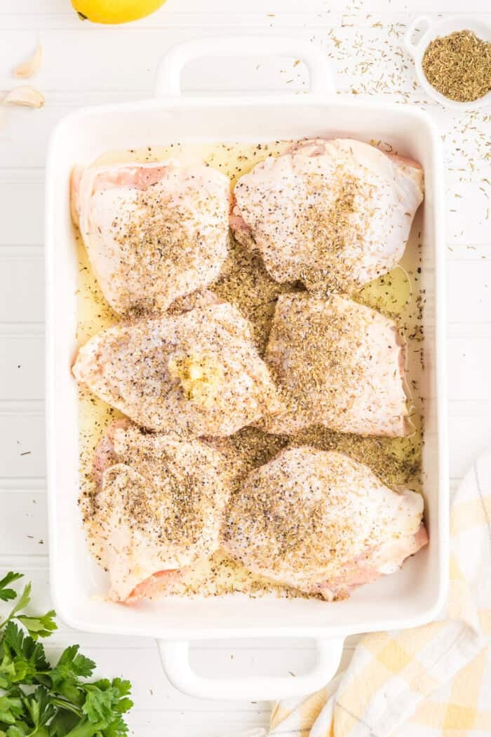 Seasoned chicken thighs in a baking dish