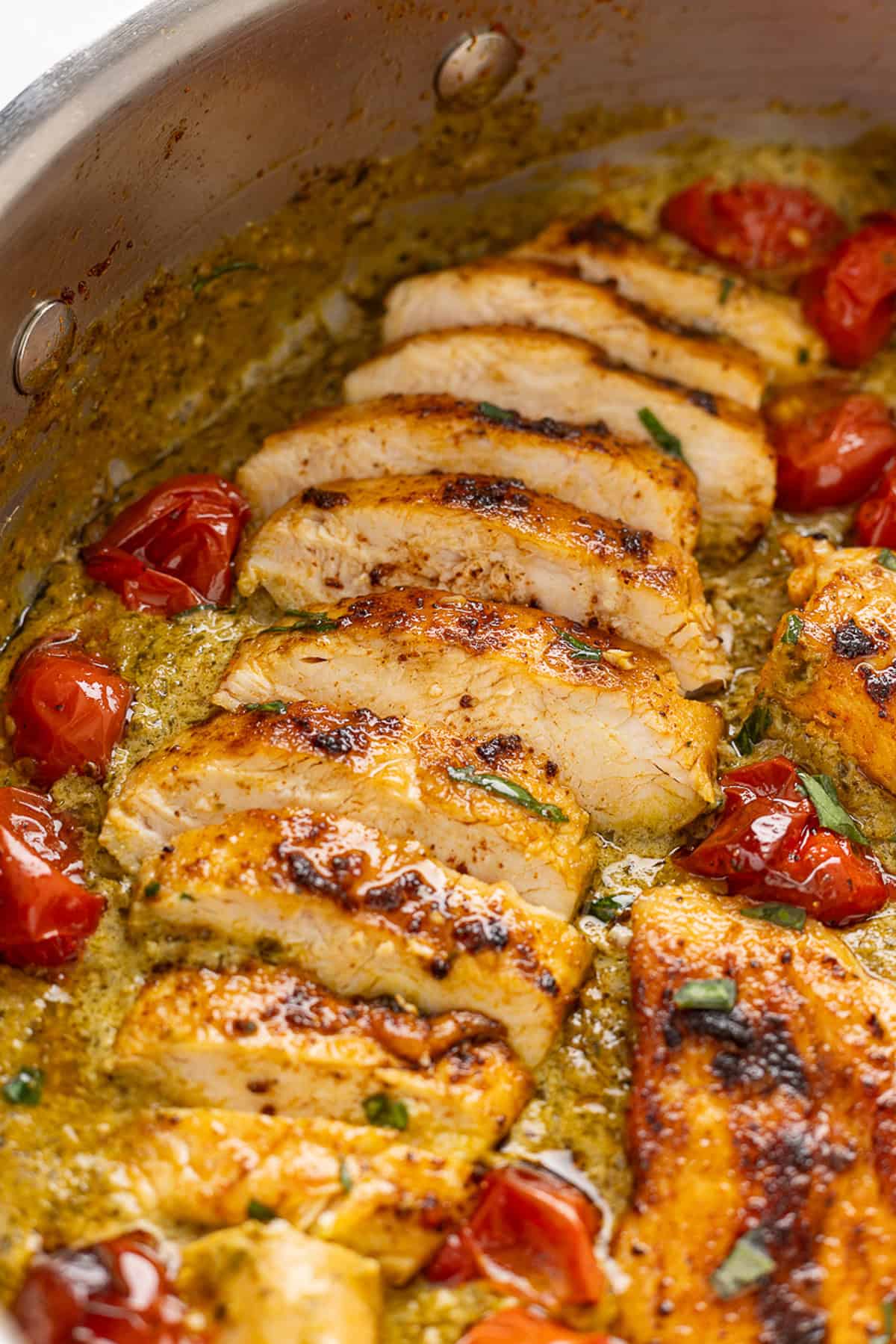 Sliced pesto chicken in a pan