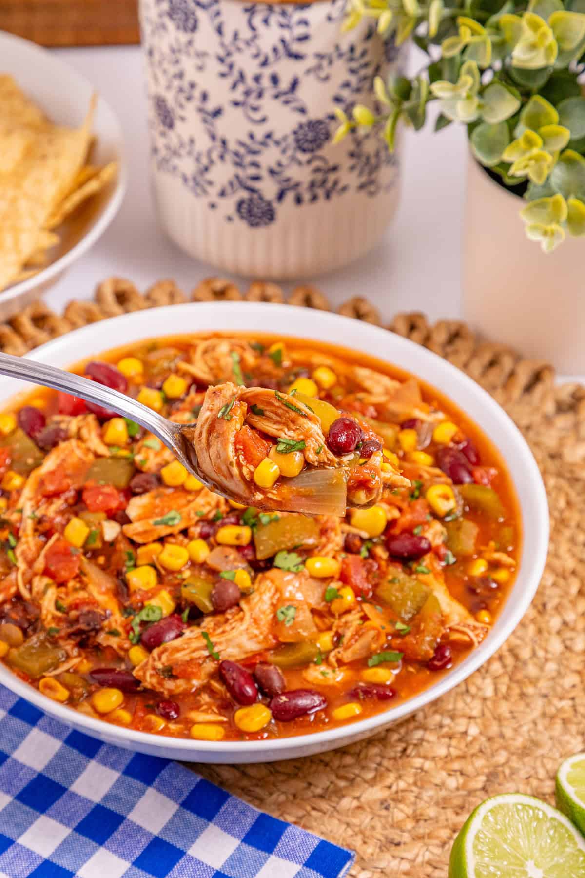 This Slow Cooker Chicken Chili is a “set it and forget it” recipe that’s perfect for busy weeknights. Hearty, filling, and super easy to make! A white bowl of slow cooker chicken chili