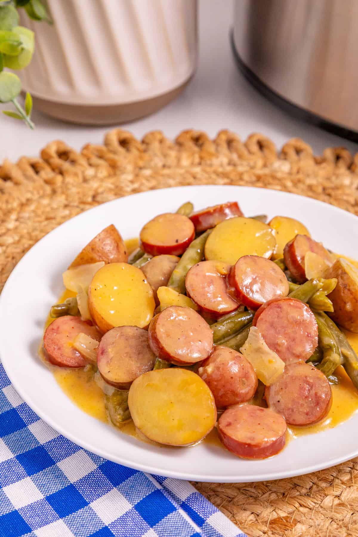 Baby potatoes, smoked sausage, and green beans are slow-cooked in Cajun seasoning and cream of chicken soup in this Crockpot Swamp Potatoes recipe. It’s an easy, flavorful dump-and-go recipe that’s perfect for busy weekends. A plate of swamp potatoes