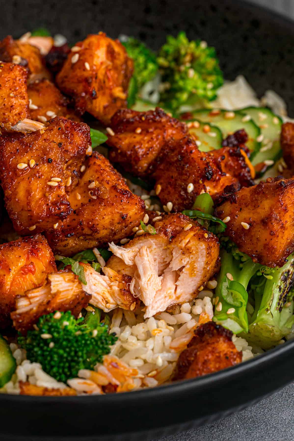 Close up of air fryer salmon bites over rice with broccoli