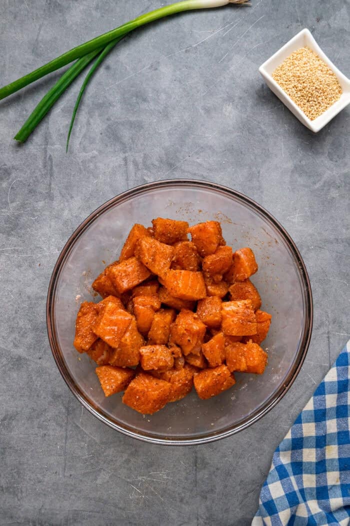 A bowl of seasoned pieces of salmon