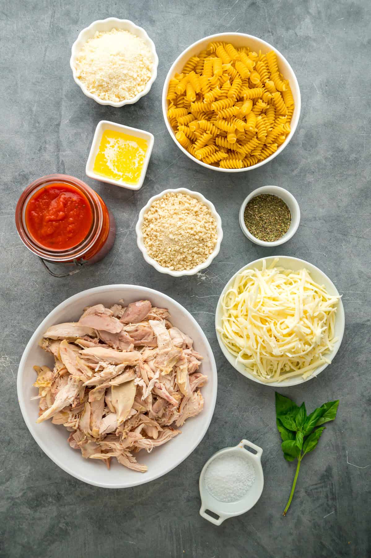 Overhead view of ingredients needed to make chicken parmesan casserole