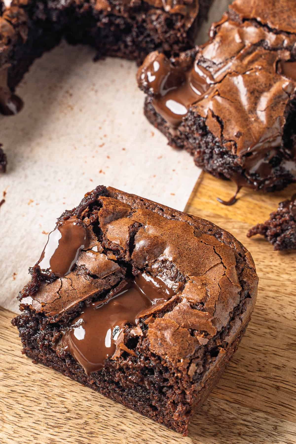baked brownie cut into a square with melted chocolate on top