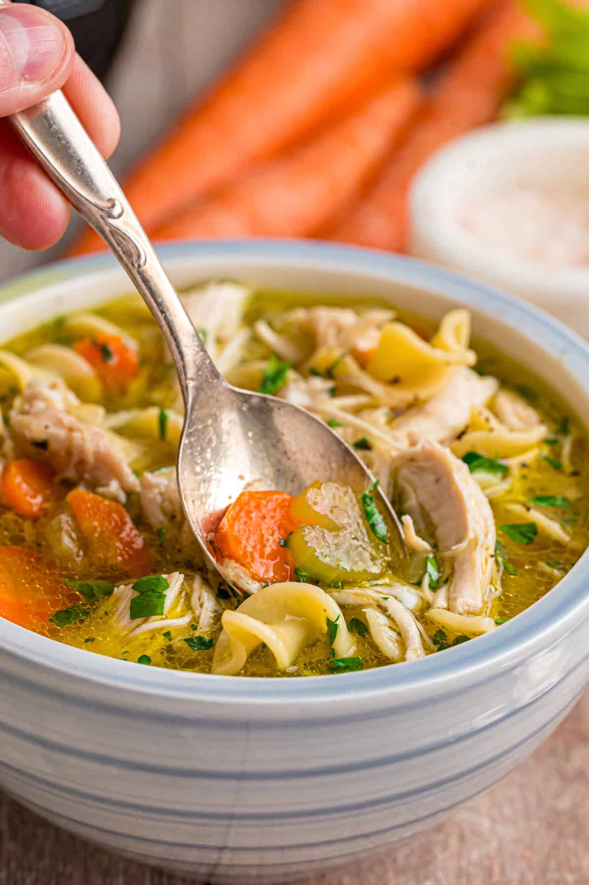 With egg noodles, shredded chicken, carrots, and celery, this Instant Pot Chicken Noodle Soup is classic comfort food made quick and easy. A spoon in a bowl of Instant Pot chicken noodle soup
