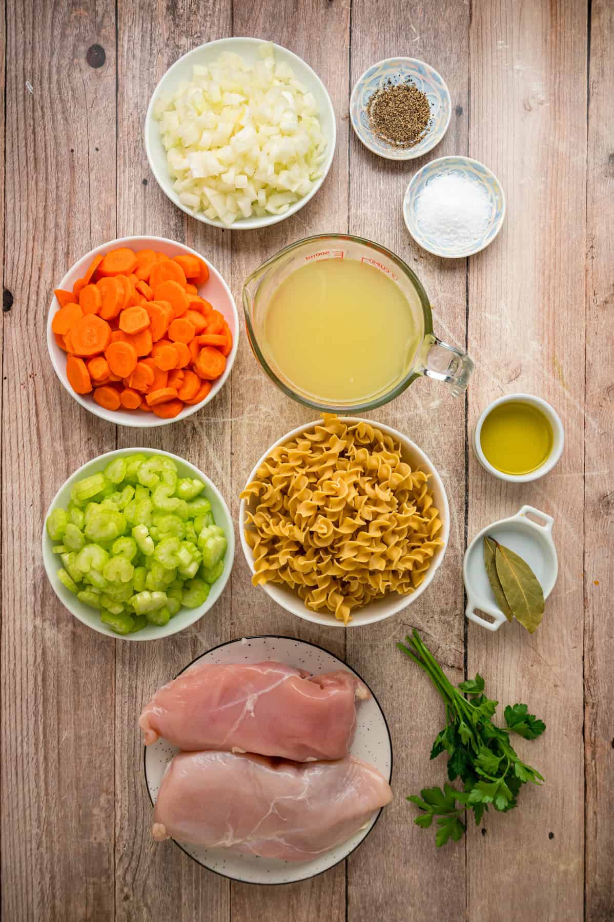 With egg noodles, shredded chicken, carrots, and celery, this Instant Pot Chicken Noodle Soup is classic comfort food made quick and easy. Overhead view of ingredients needed to make Instant Pot chicken noodle soup