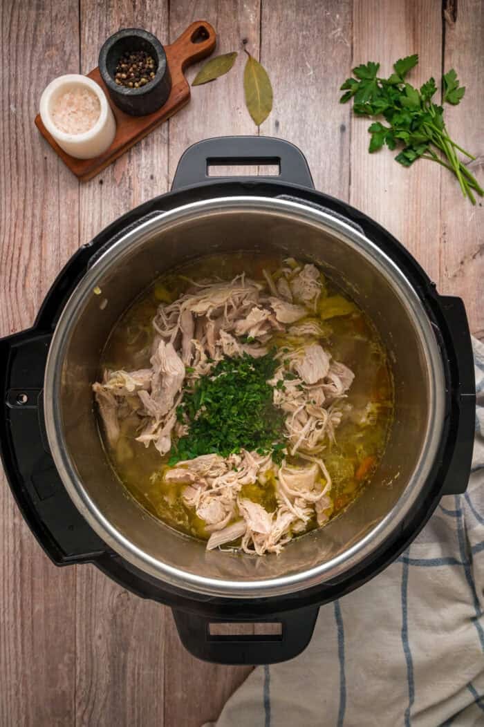 With egg noodles, shredded chicken, carrots, and celery, this Instant Pot Chicken Noodle Soup is classic comfort food made quick and easy. Shredded chicken and parsley added to broth in the Instant Pot