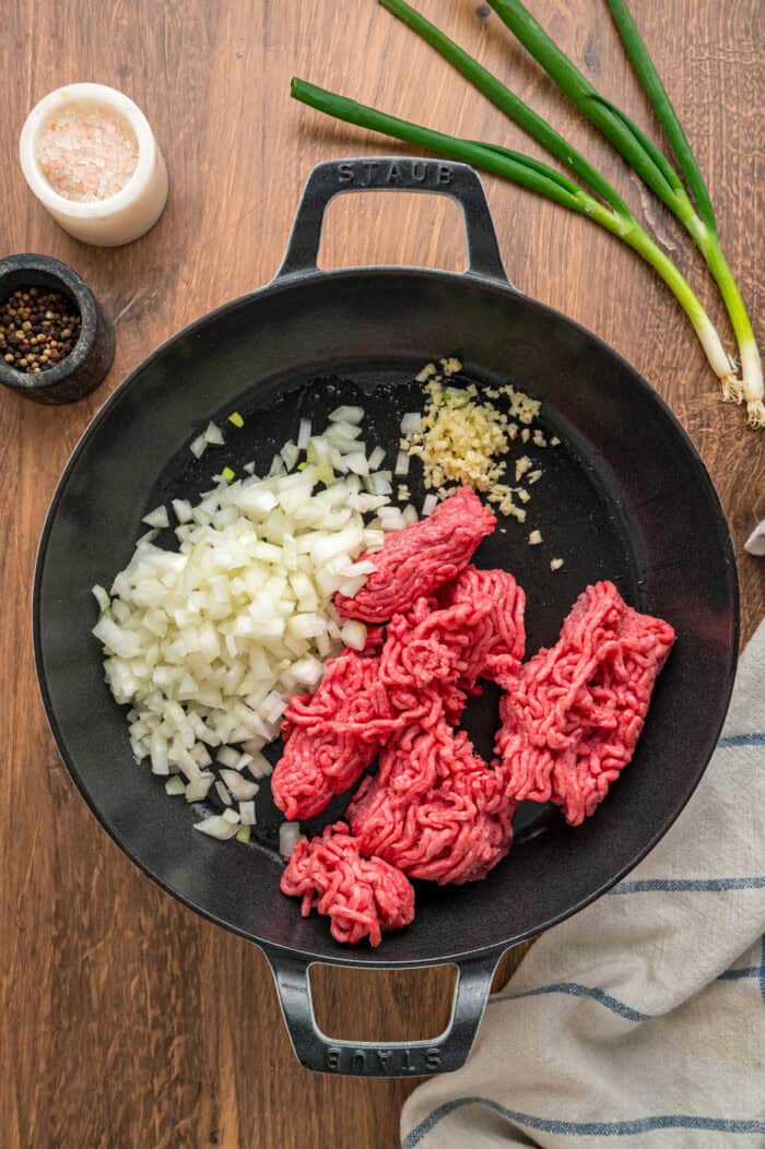 With noodles coated in sour cream, meat sauce, and lots of cheese, this sour cream noodle bake is quick, easy & comforting. Onion, garlic, and ground beef in a skillet