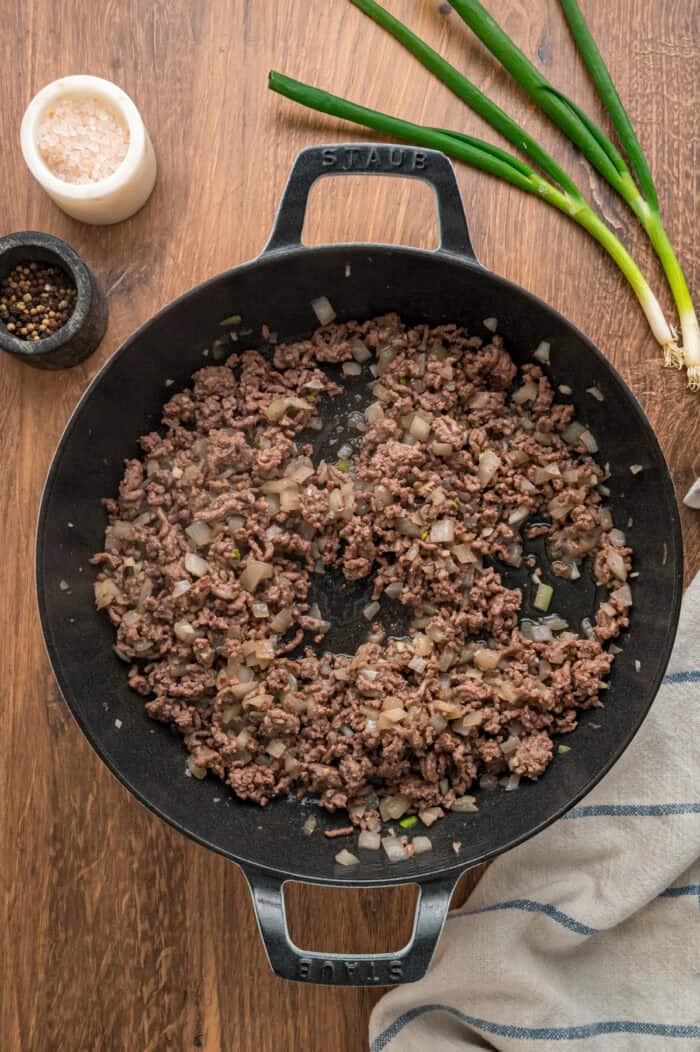With noodles coated in sour cream, meat sauce, and lots of cheese, this sour cream noodle bake is quick, easy & comforting. Cooked ground beef in a skillet