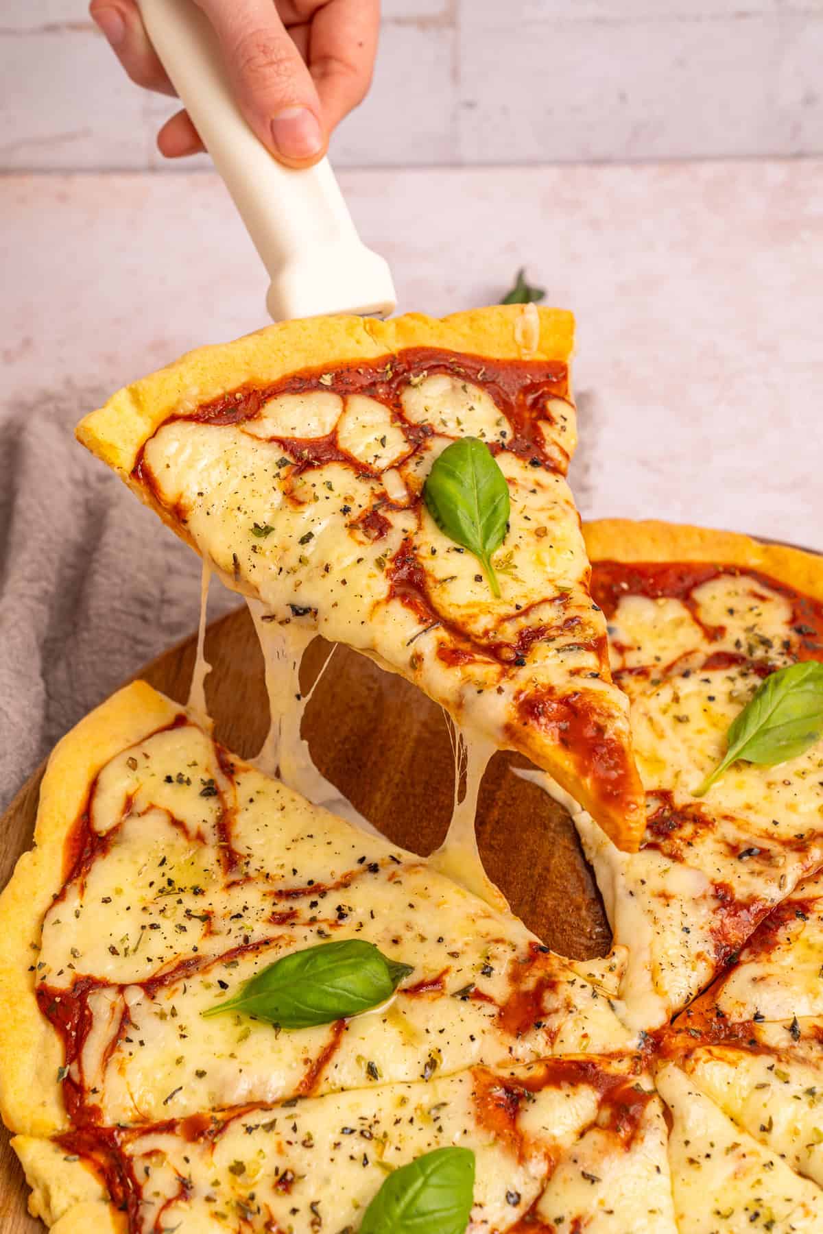 Serving a slice of pizza made with cottage cheese pizza crust