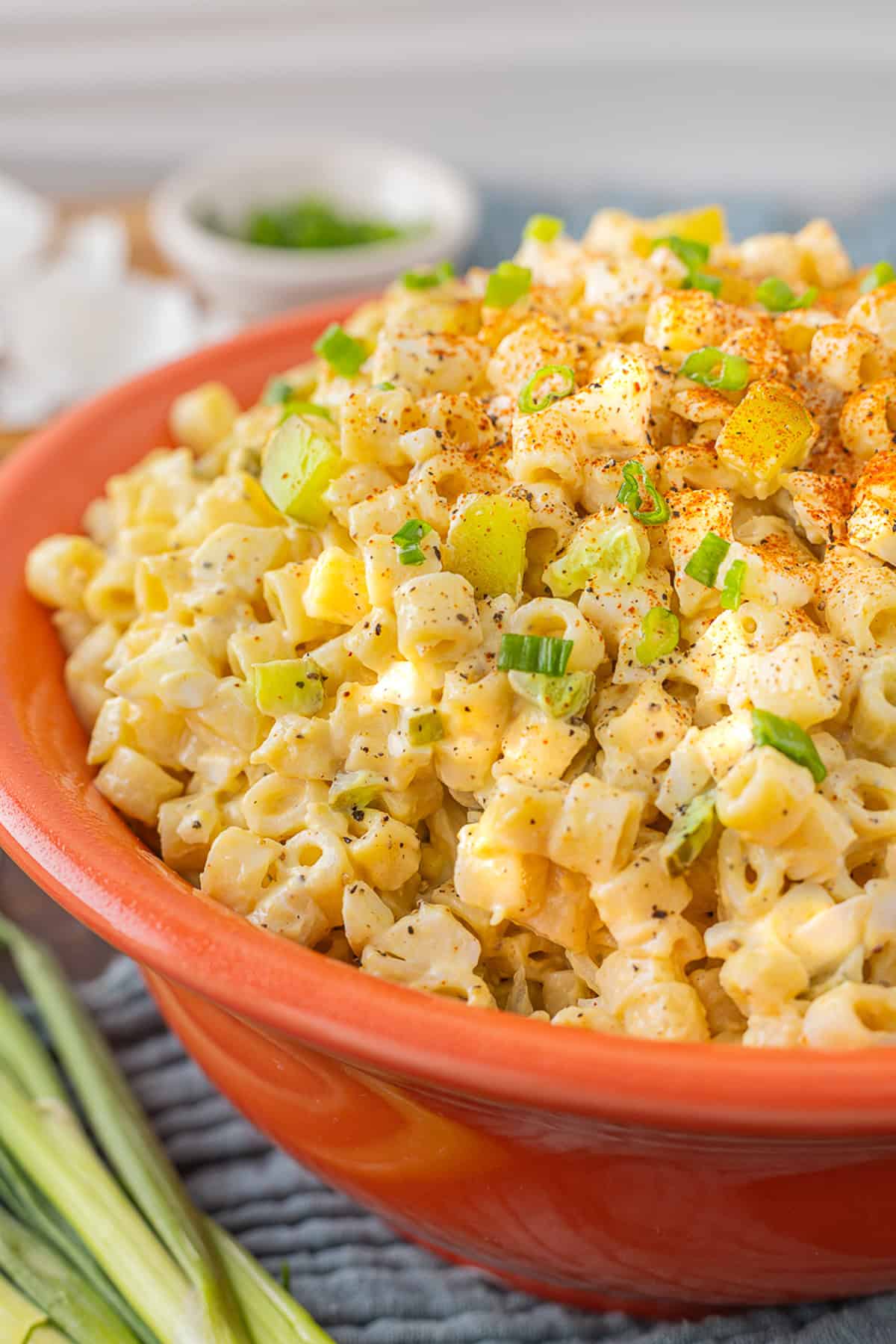 An orange bowl of deviled egg pasta salad