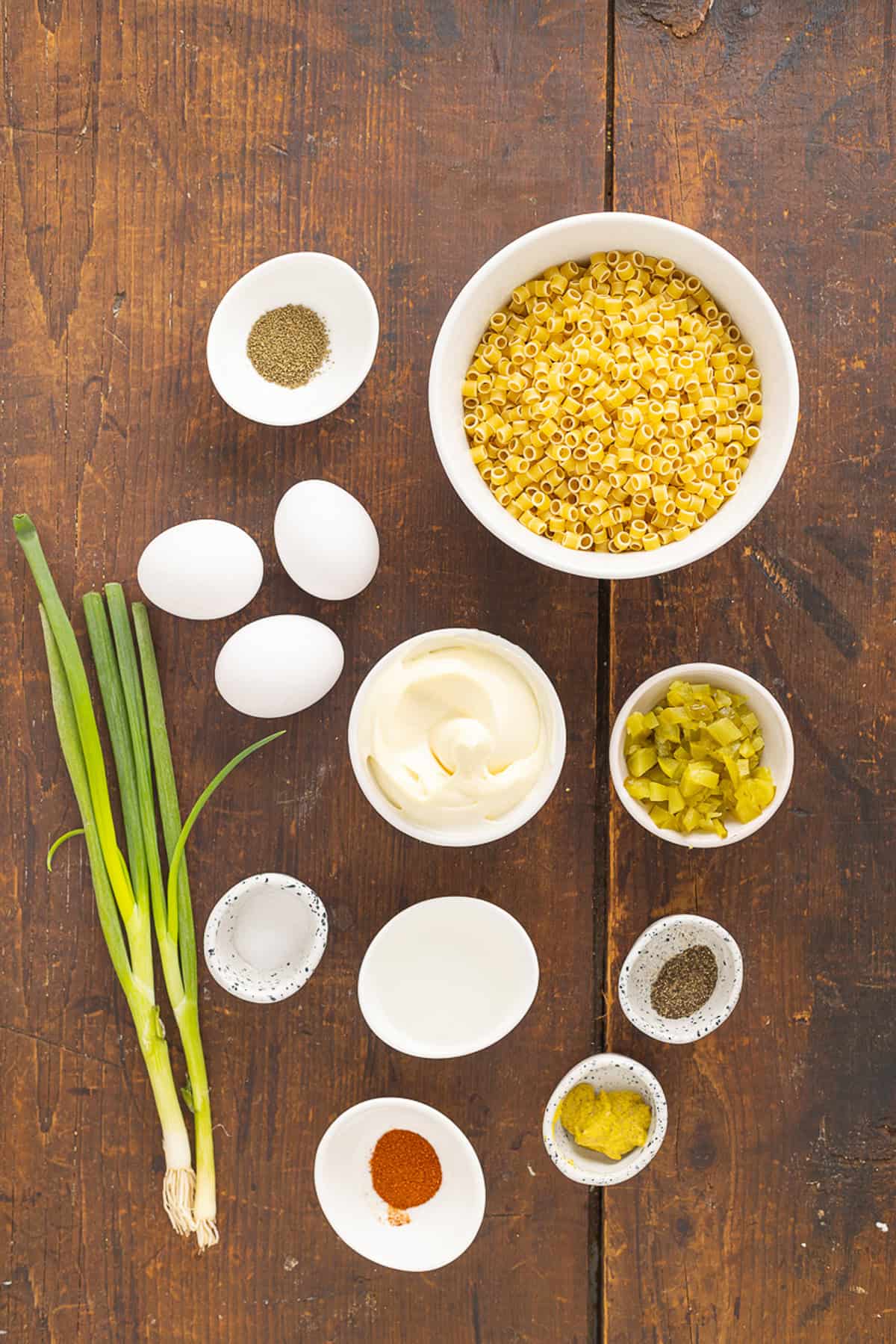 Overhead view of ingredients needed to make deviled egg pasta salad
