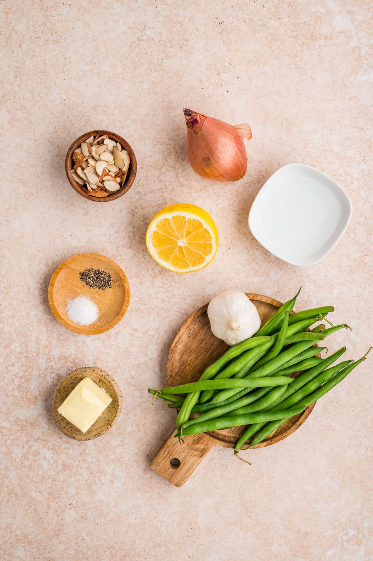 These Green Beans Almondine are a quick and easy side dish made with tender crisp green beans, buttery shallots, and toasted almonds. Overhead view of ingredients needed to make green beans almondine
