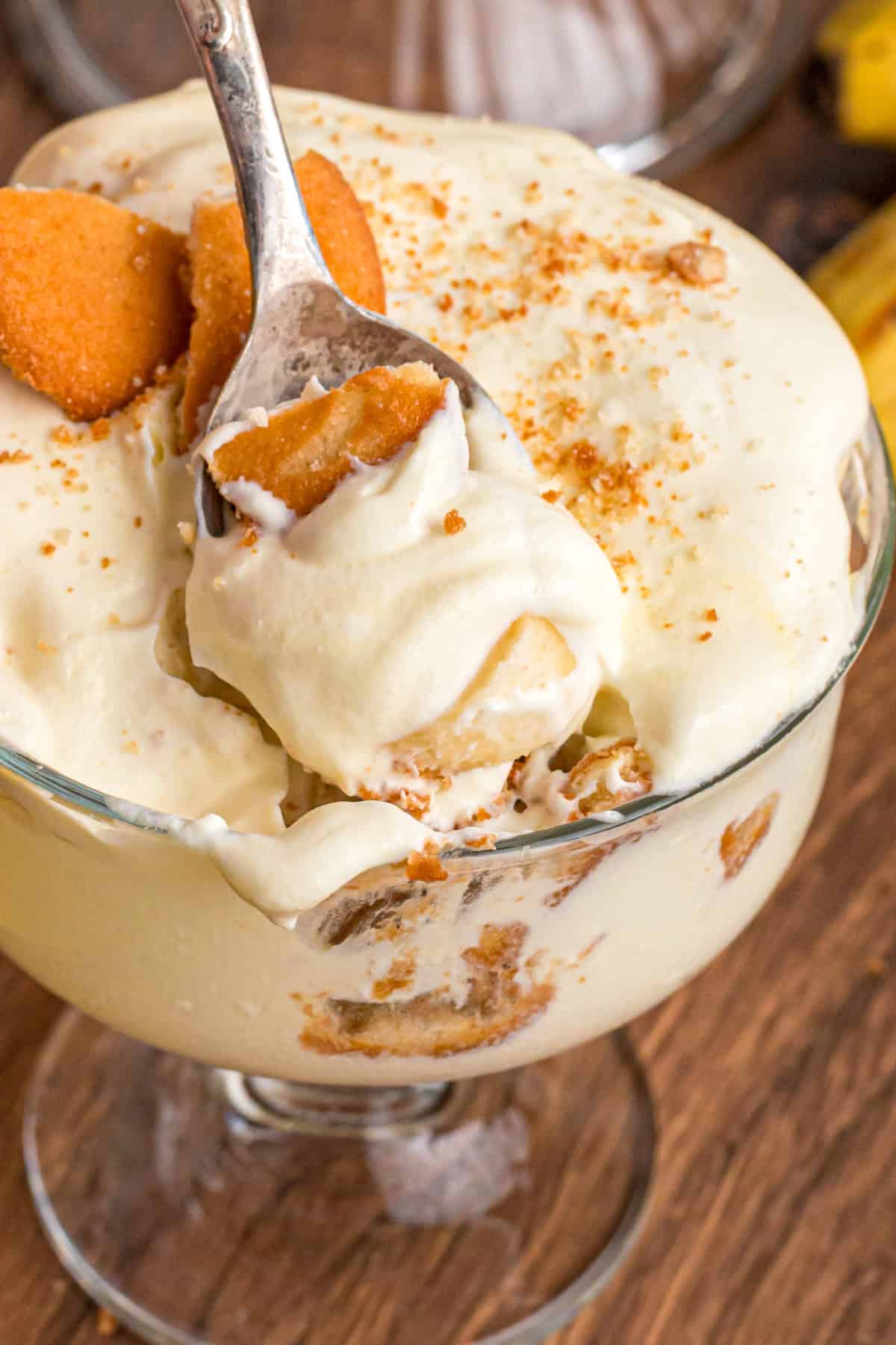With light, airy layers of pudding, fresh banana slices, and Nilla wafers, this Magnolia Bakery Banana Pudding Recipe is an exact copycat. a spoon dipping into a glass dish of Magnolia Bakery Banana Pudding
