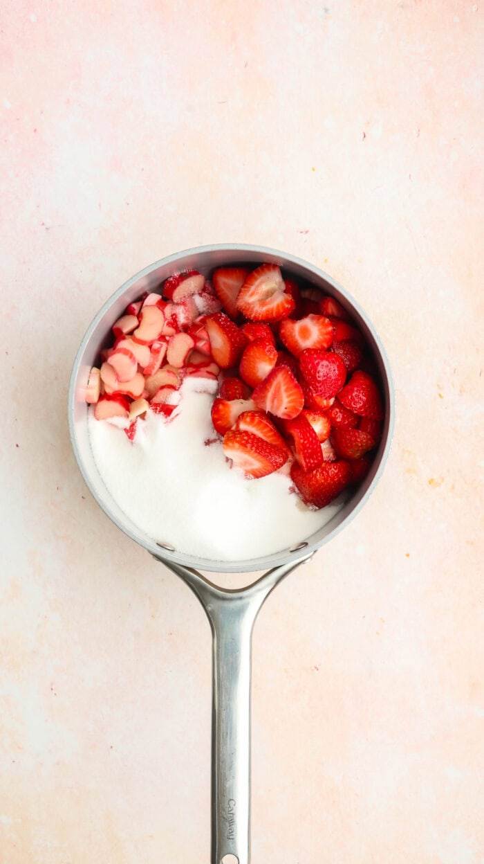 Rhubarb, strawberries, and sugar in a saucepan