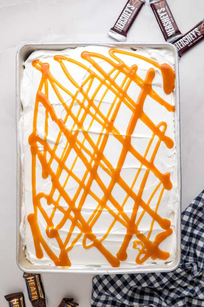 Chocolate cake is drizzled with sweetened condensed milk, caramel sauce, and whipped topping to make this decadent Better Than Sex Cake. Caramel drizzle on top of cool whip on a cake