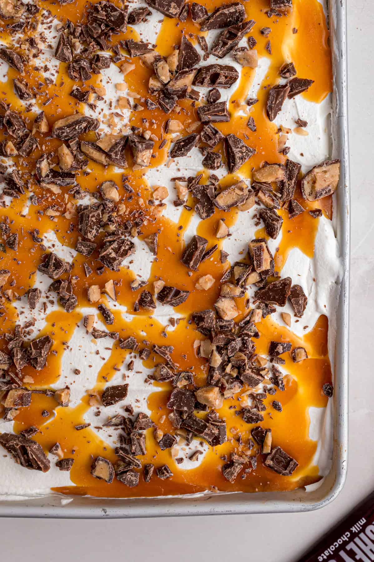 Chocolate cake is drizzled with sweetened condensed milk, caramel sauce, and whipped topping to make this decadent Better Than Sex Cake. Overhead view of better than sex cake