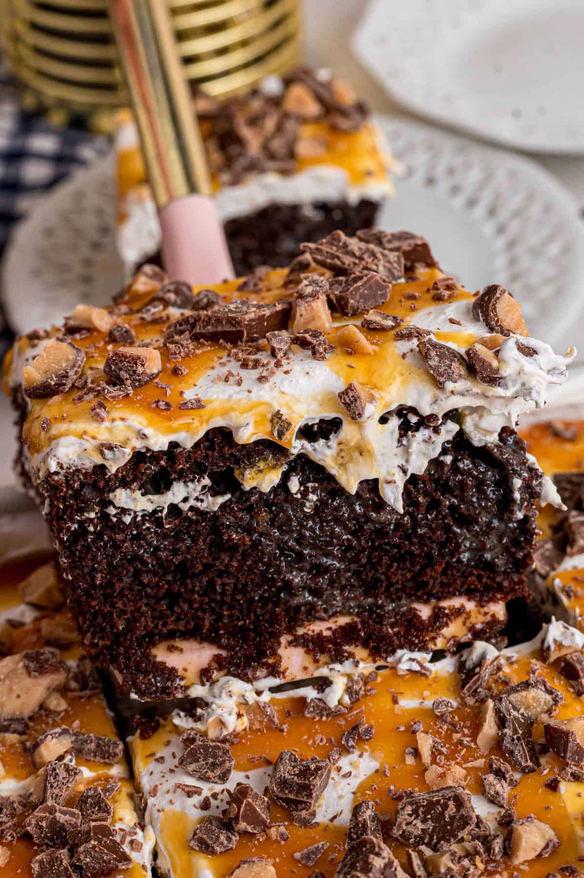 Chocolate cake is drizzled with sweetened condensed milk, caramel sauce, and whipped topping to make this decadent Better Than Sex Cake. Serving a slice of better than sex cake