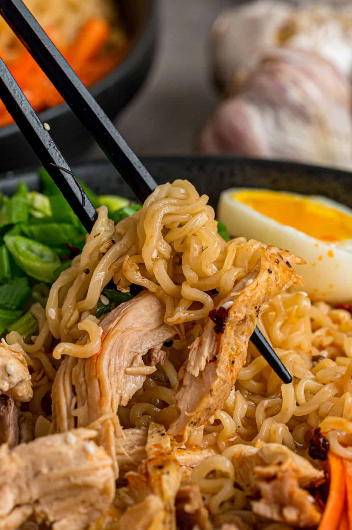 This easy Chicken Ramen recipe turns instant ramen noodles into a flavorful and filling weeknight dinner. Ready in 35 minutes! Chopsticks in a bowl of chicken ramen