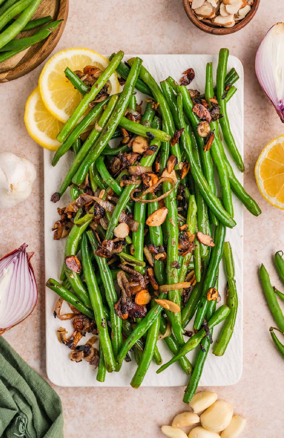 These Green Beans Almondine are a quick and easy side dish made with tender crisp green beans, buttery shallots, and toasted almonds. Green Beans Almondine on a platter