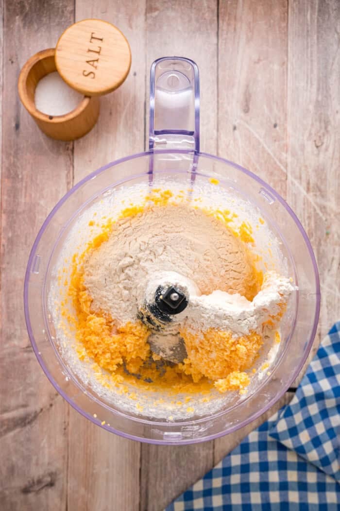 Flour added to cheddar cheese and butter in the food processor
