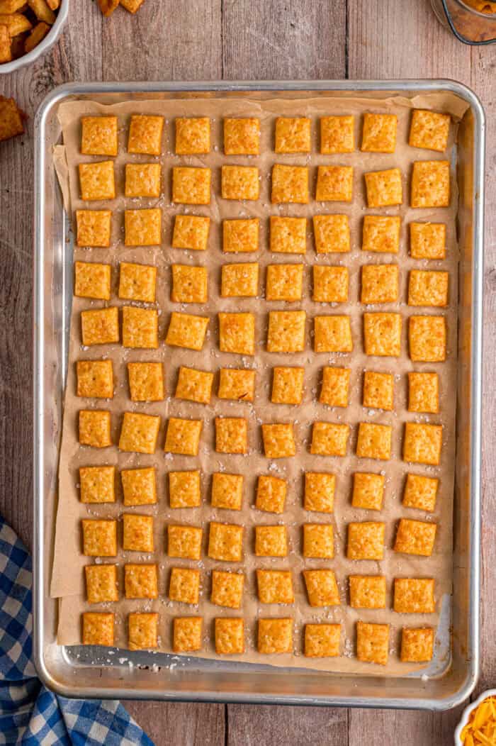 Overhead view of homemade Cheez Its on a baking sheet