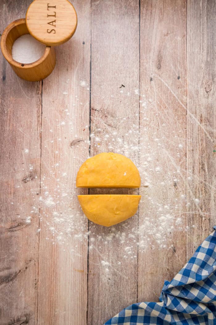 A disc of Cheez It dough cut in half
