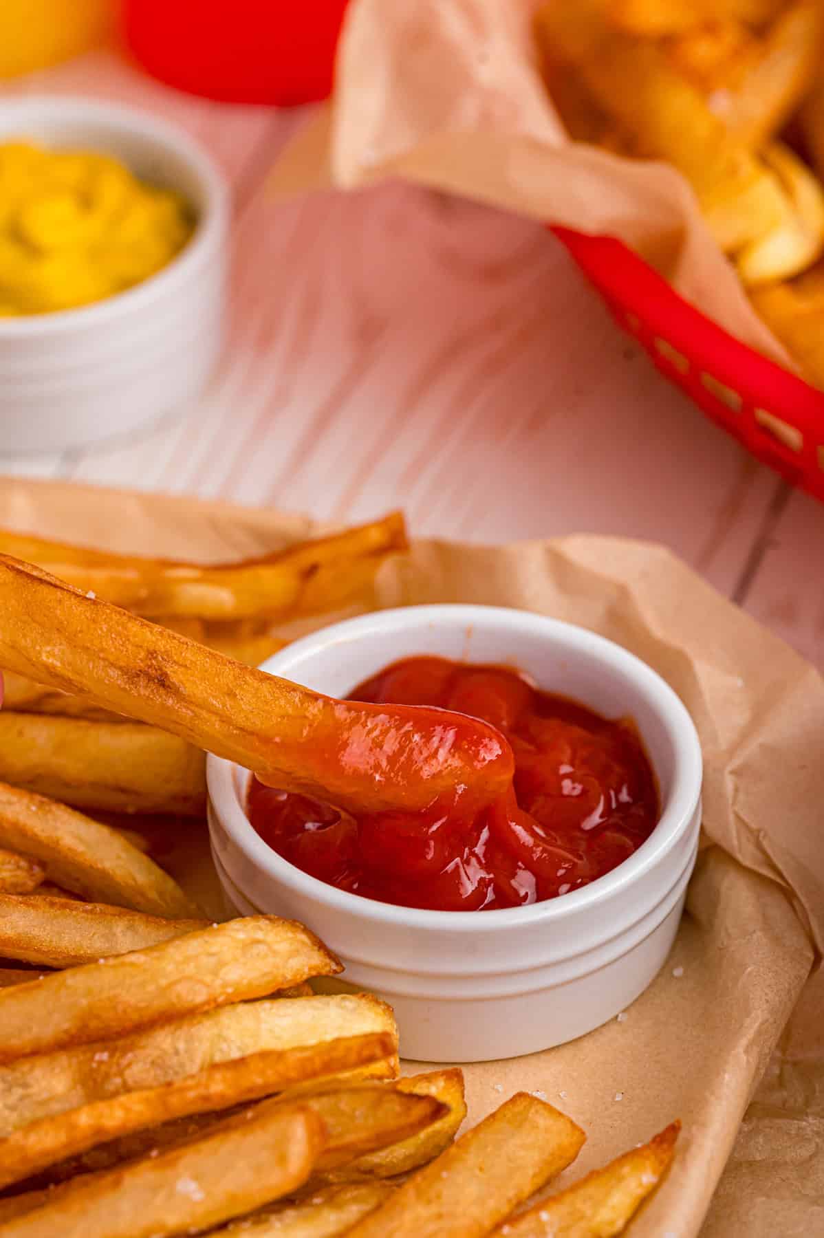 These easy homemade French Fries are made with just Russet potatoes, salt, and oil. Tender on the inside and crispy on the outside! A crispy homemade French fry dipped in ketchup