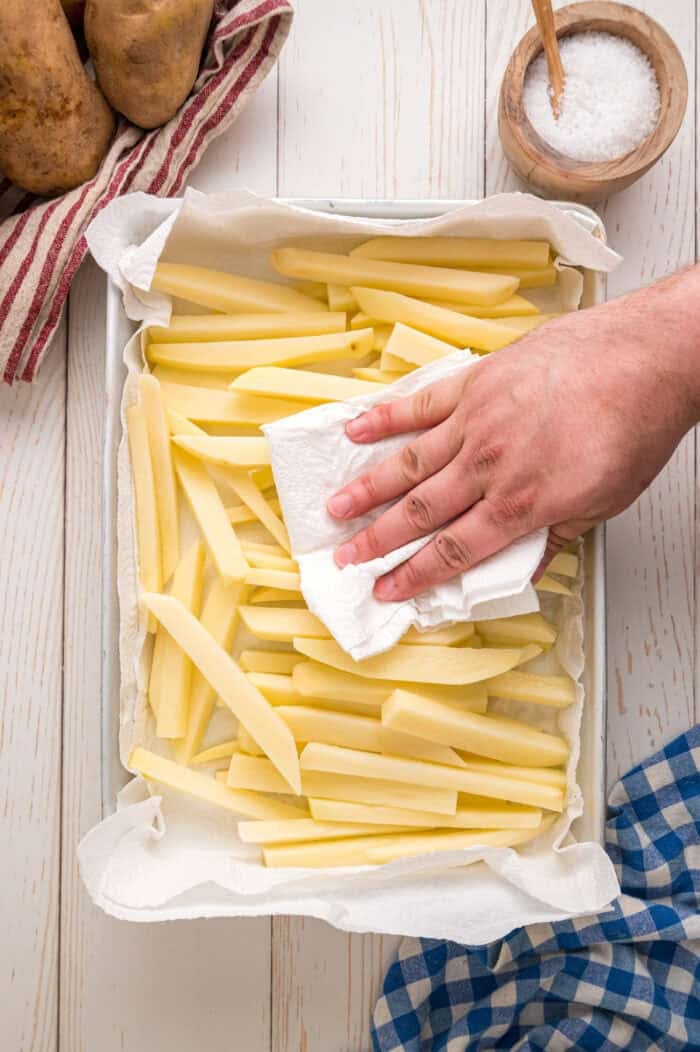 These easy homemade French Fries are made with just Russet potatoes, salt, and oil. Tender on the inside and crispy on the outside! Patting homemade fries with paper towels