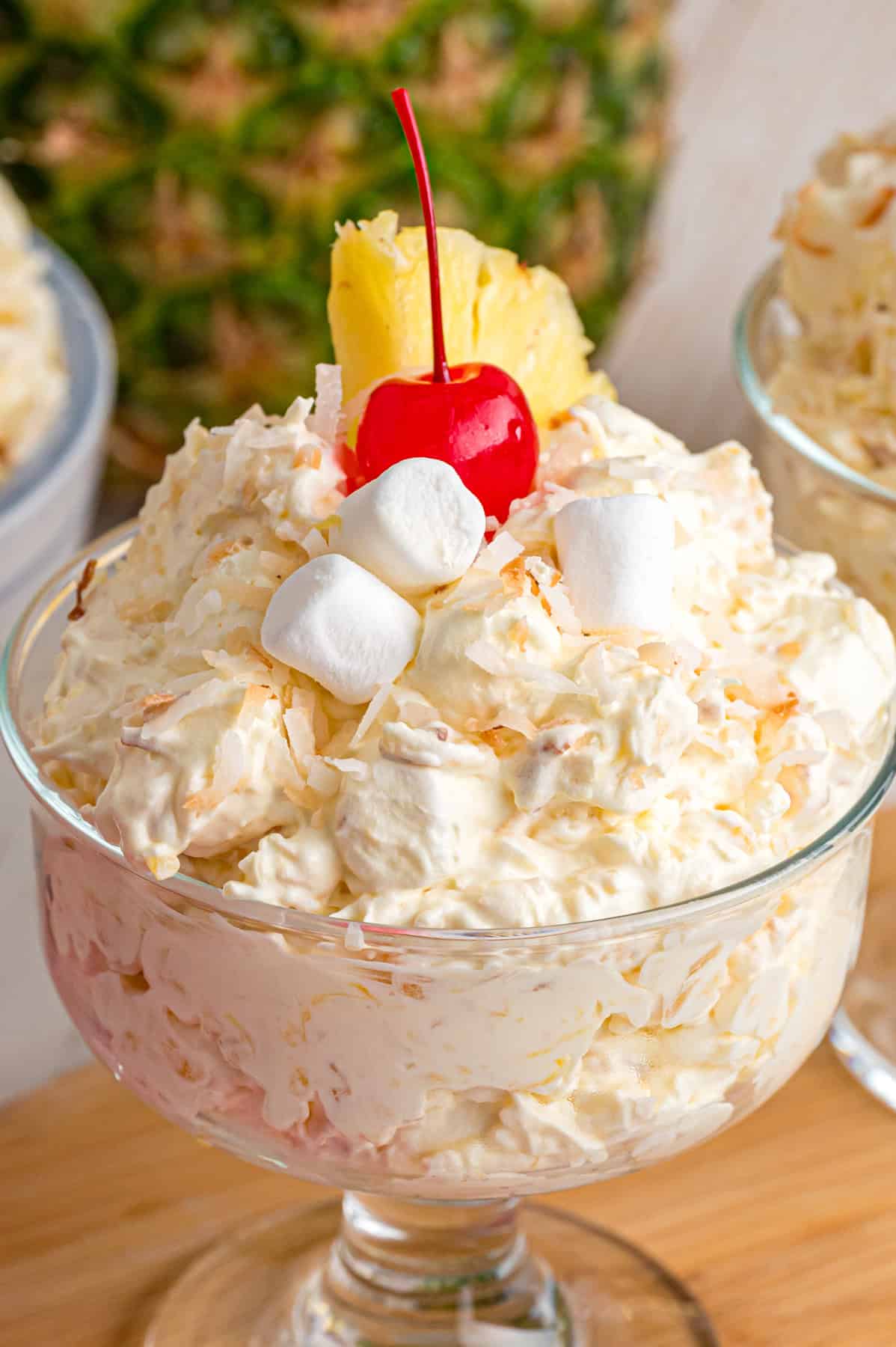 A glass dessert dish with pineapple fluff