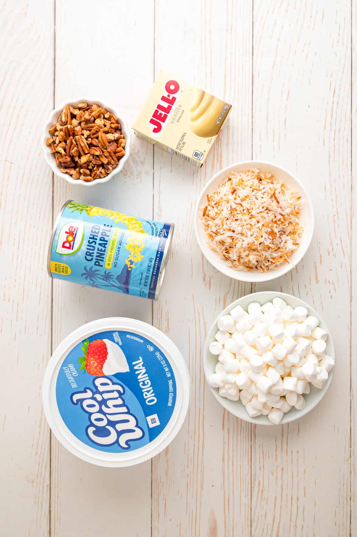 Pineapple Fluff is a quick and easy no-bake dessert that’s perfect for summer, with crushed pineapple, toasted coconut, and marshmallows. Overhead view of ingredients needed to make pineapple fluff recipe