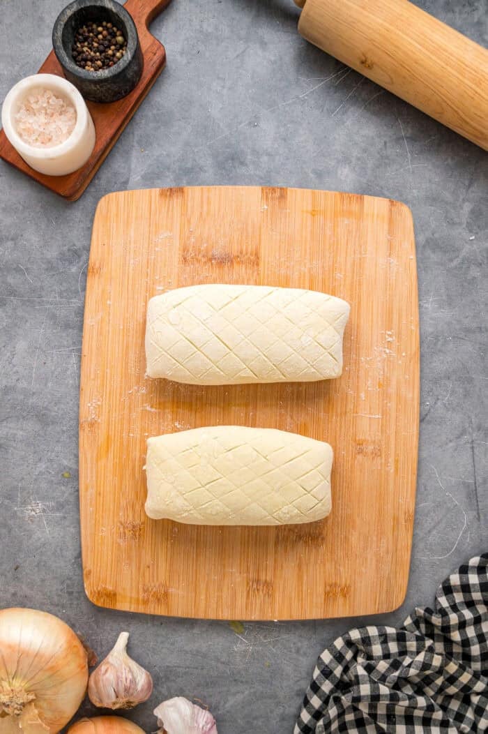 This Salmon Wellington recipe features tender salmon topped with a cream cheese spinach filling and wrapped in a flaky puff pastry. The puff pastry wrapped around the salmon.