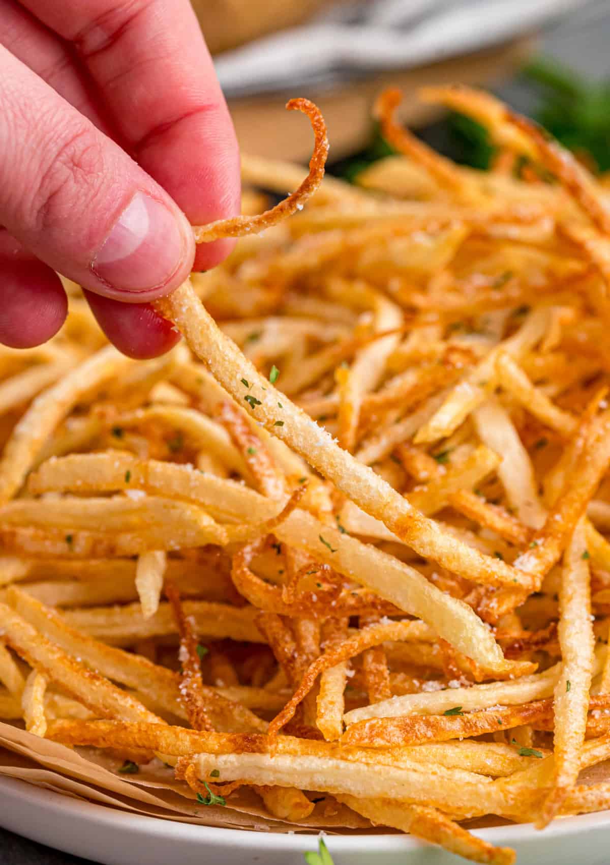 Made with just 3 ingredients, these Shoestring Fries are long, thin, and fry in just a few minutes. Serve with your favorite dipping sauces. grabbing shoestring fries