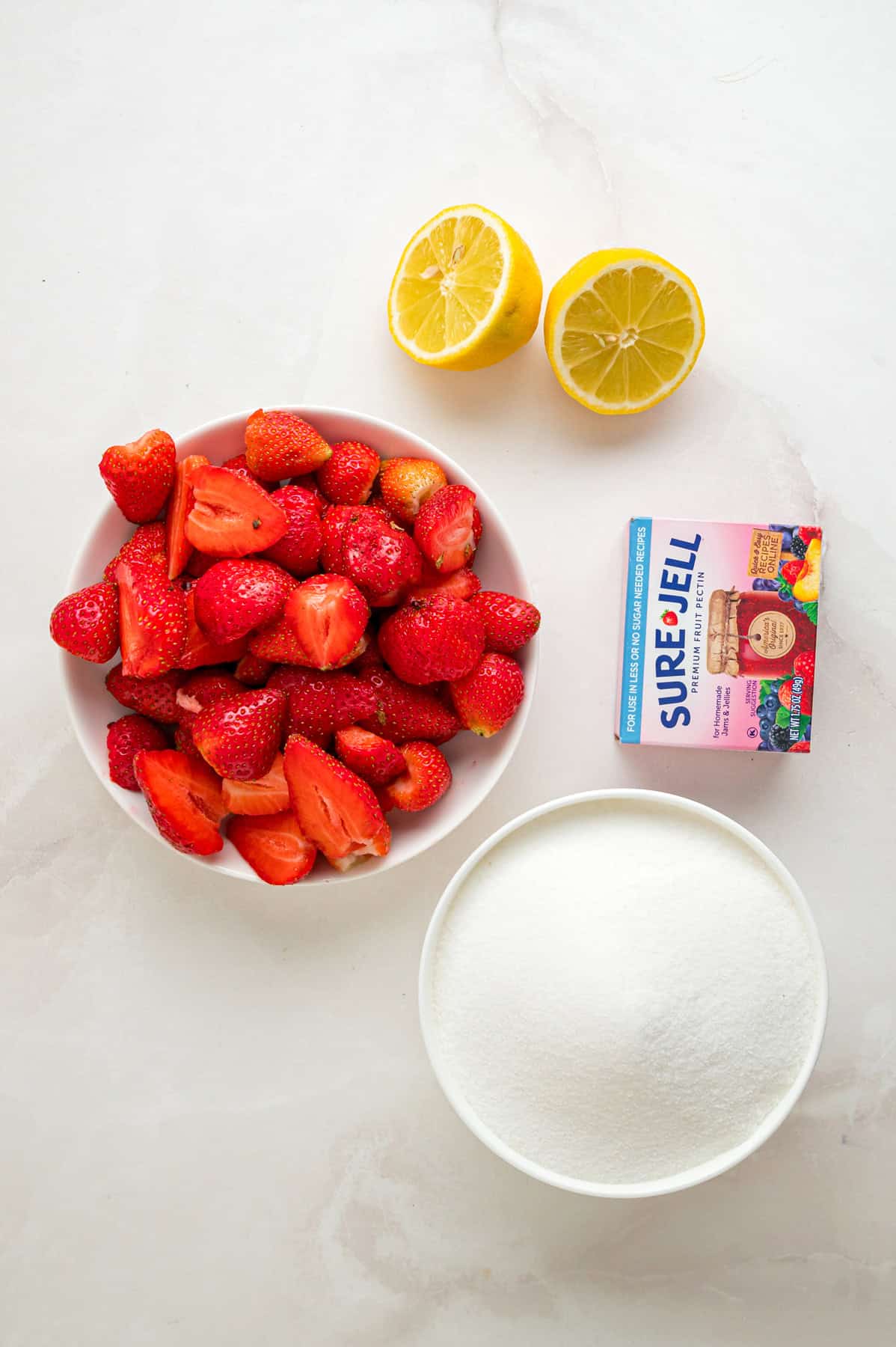 Made with just 4 ingredients, this Strawberry Jam recipe is quick and easy to make with no canning equipment required. Overhead view of ingredients needed to make strawberry jam