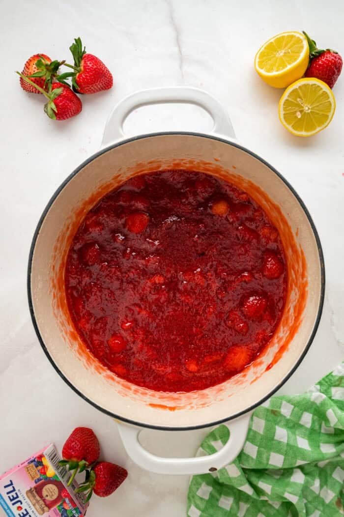 Made with just 4 ingredients, this Strawberry Jam recipe is quick and easy to make with no canning equipment required. Overhead view of strawberry jam in a pot