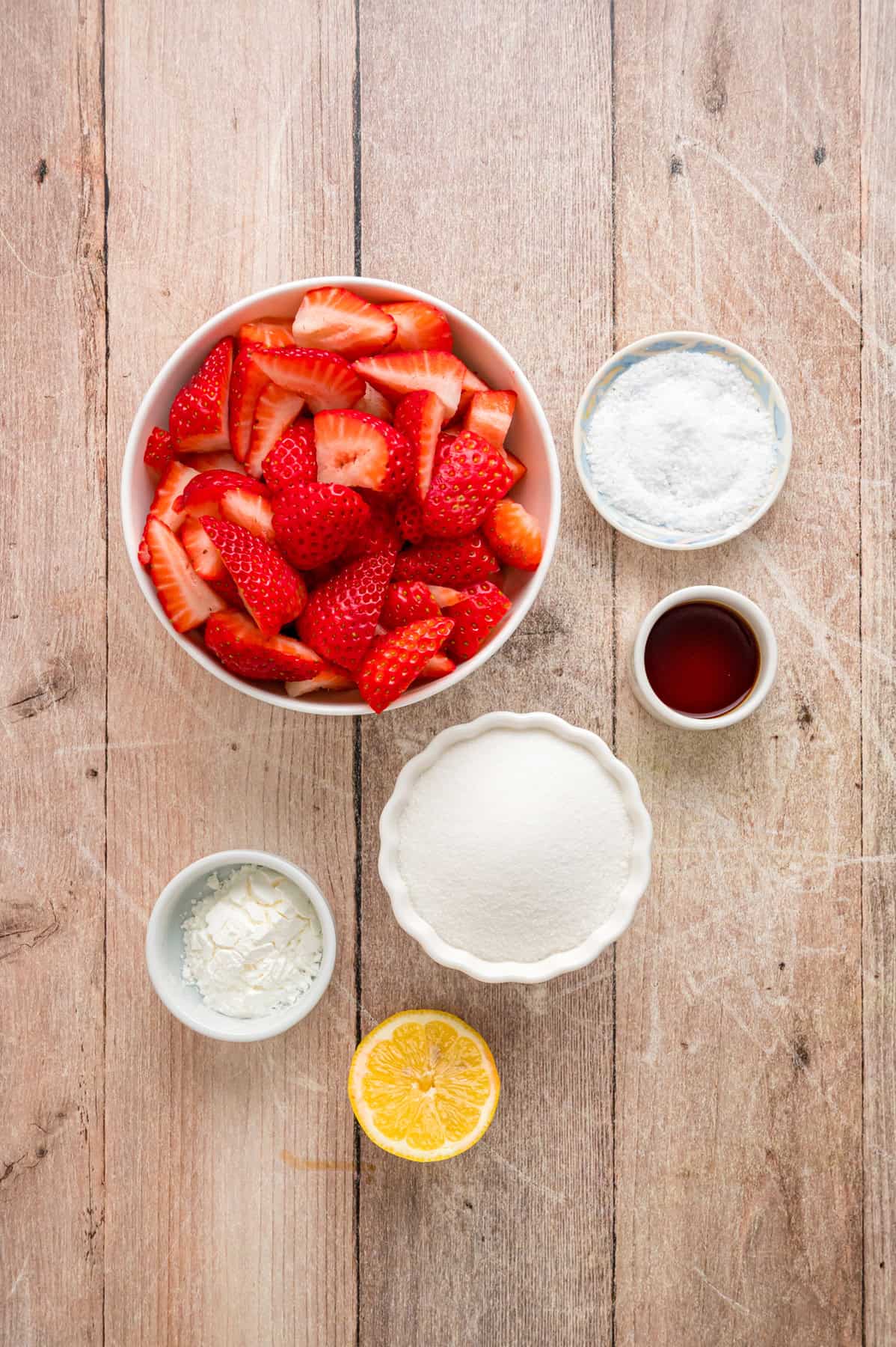 This easy Strawberry Sauce is made with just 6 ingredients in less than 20 minutes, with chunks of fresh strawberries in every bite. Overhead view of ingredients needed to make strawberry sauce