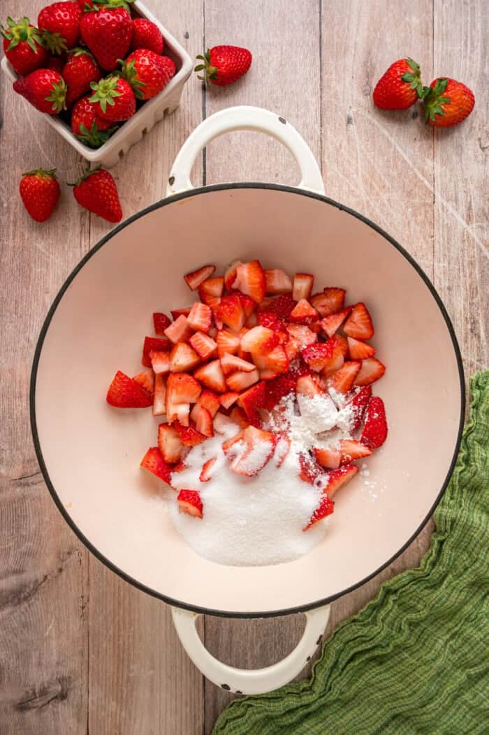 This easy Strawberry Sauce is made with just 6 ingredients in less than 20 minutes, with chunks of fresh strawberries in every bite. Sugar and chopped strawberries in a pan