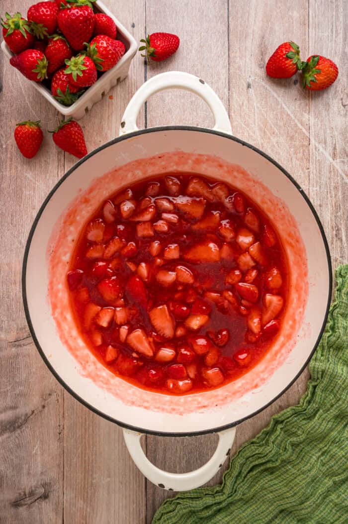 This easy Strawberry Sauce is made with just 6 ingredients in less than 20 minutes, with chunks of fresh strawberries in every bite. Overhead view of strawberry sauce in a pan