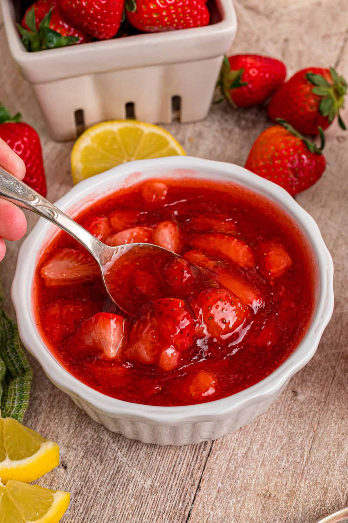 This easy Strawberry Sauce is made with just 6 ingredients in less than 20 minutes, with chunks of fresh strawberries in every bite. A spoon in a bowl of strawberry sauce