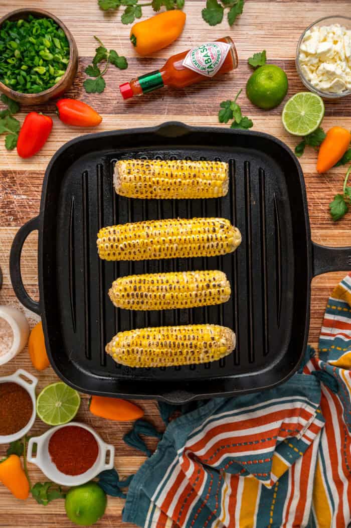 Charred corn kernels, feta cheese, and pasta are tossed in a creamy dressing to make this Street Corn Pasta Salad. Charred ears of corn on a grill pan